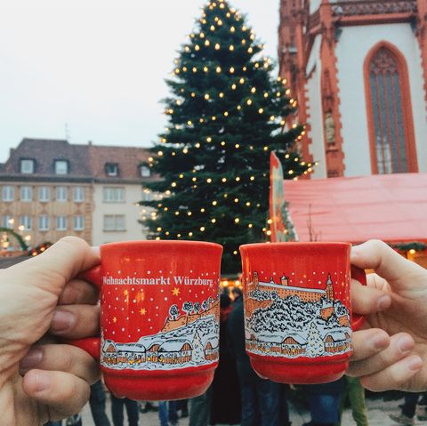 drinking gluhwein mulled wine at christmas market in germany