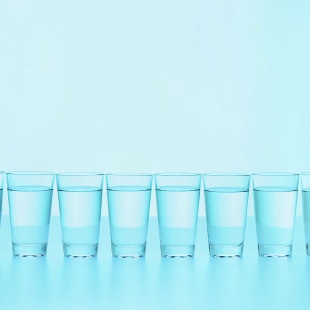 glasses of water in a row on a blue background