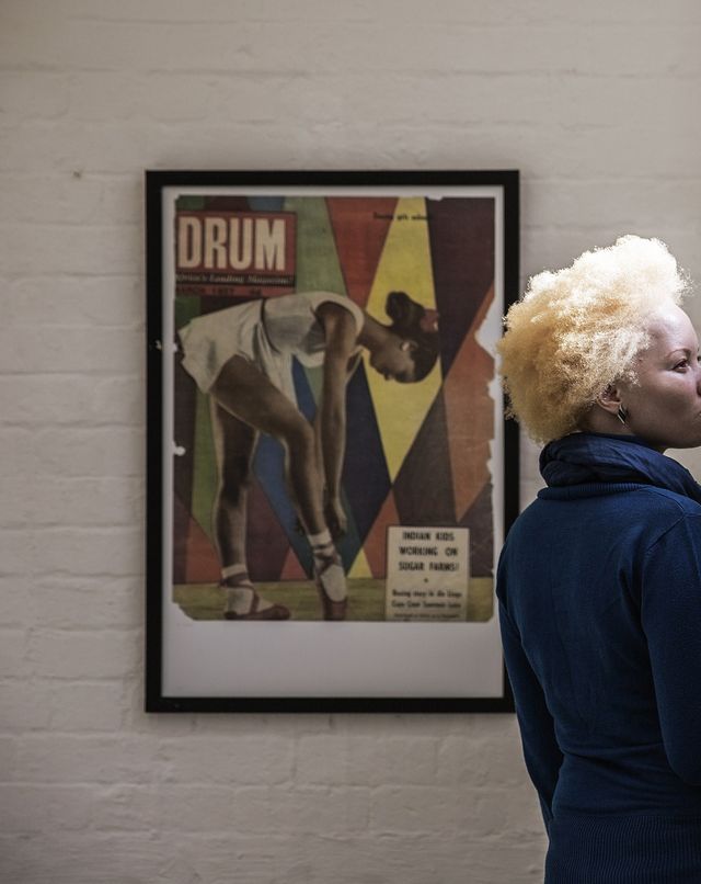 to go with afp story by claudine renaud south african lawyer and part time fashion model thando hopa, an albino, visits an exhibition of black culture drum magazine front pages at arts on main on june 13, 2015 in johannesburg thando hopa grew up in the shade, her porcelain skin hidden under long sleeves and sunscreen until the day this south african said goodbye to her complexes and decided to fight prejudice against albinos by becoming a model petite and born with a genetic anomaly that left her skin de pigmented from head to toe, hopa entered the fashion world without the usual vital statistics required of a catwalk model but ghostly, no make up barring a vivid fuchsia on her lips, her hair sculpted to a magnificent bleached height, she exploded onto the cover of the first forbes life africa back in 2013 afp photo gianluigi guercia photo credit should read gianluigi guerciaafp via getty images