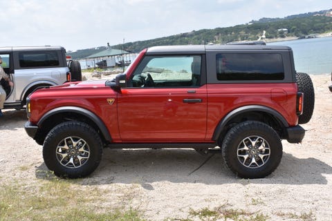 red ford bronco parked on a riverside beach in texas