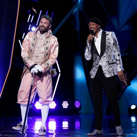 the masked singer l r brian austin green and host nick cannon in the “the group a play offs famous masked words” episode of the masked singer airing wednesday, oct 7 800 900 pm etpt on fox © 2020 fox media llc cr michael beckerfox