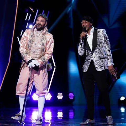 the masked singer l r brian austin green and host nick cannon in the “the group a play offs   famous masked words” episode of the masked singer airing wednesday, oct 7 800 900 pm etpt on fox © 2020 fox media llc cr michael beckerfox