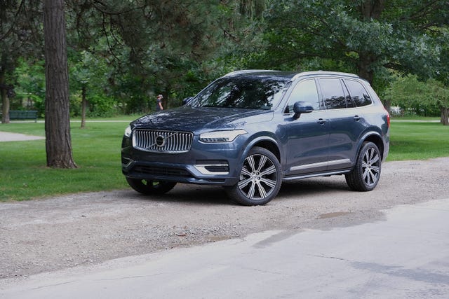 volvo xc90 recharge in blue parked next to a road