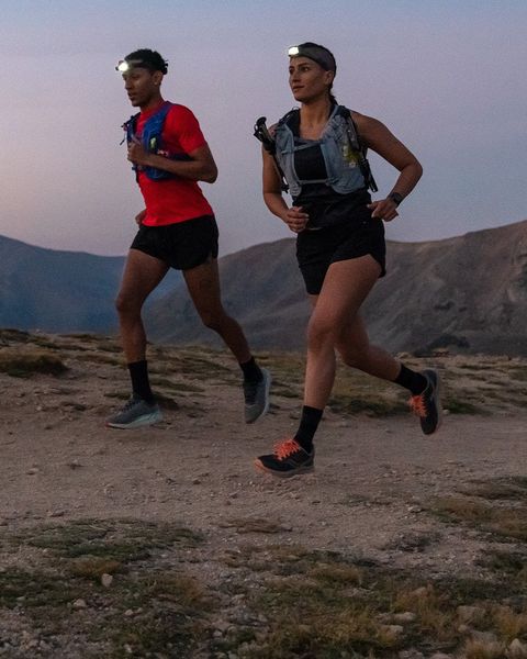 man and woman running wearing osprey duro dyna bag