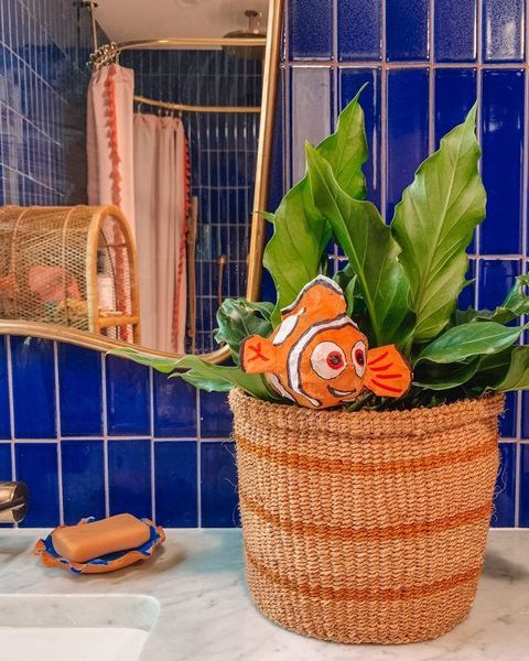 papier mache fish in basket with plant