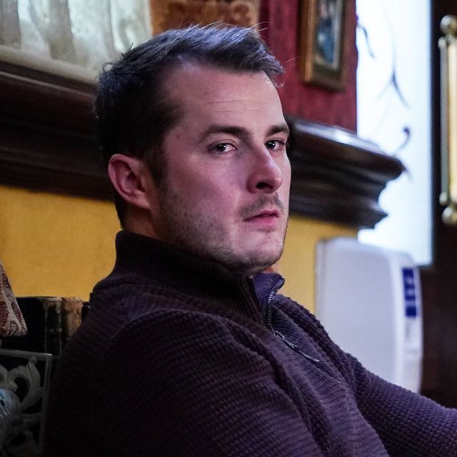 eastenders' ben mitchell, played by max bowden, sits in the queen vic pub