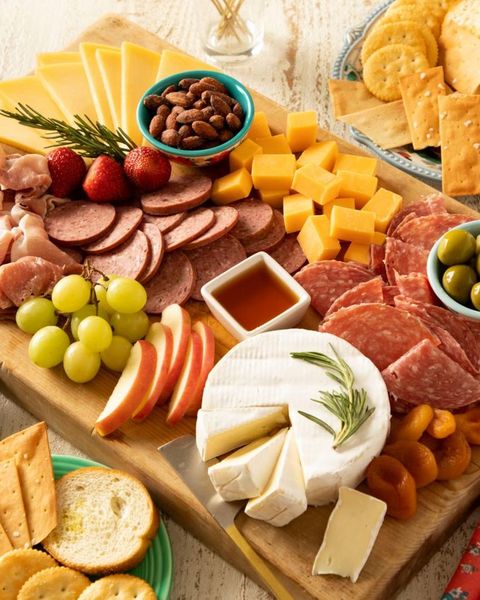 charcuterie board with brie grapes cheeses and meats