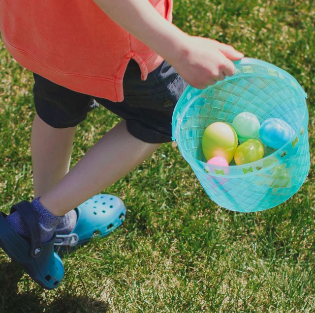 kid holding blue easter basket wearing crocs