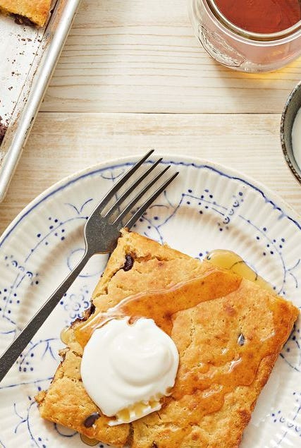 pb chocolate sheet pan pancakes with syrup and whipped cream on top