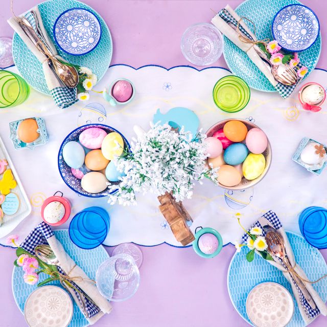 easter tabletop with eggs, flowers, and sugar cookies