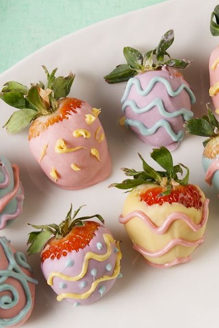 strawberries decorated with candy melts to look like easter eggs
