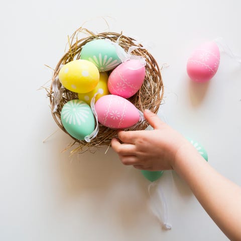 Easter Facts Hand Reaching for Colorful Eggs in Basket