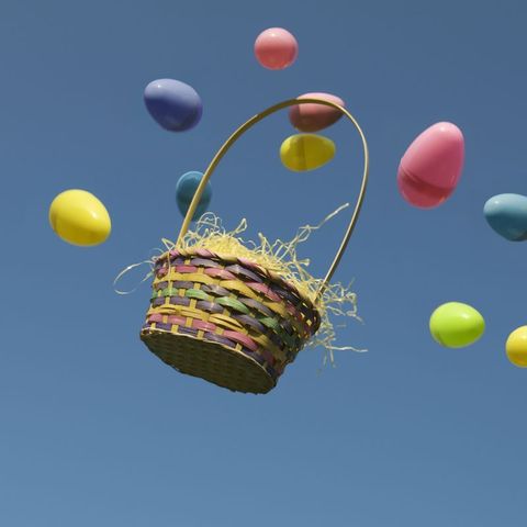 easter basket and plastic eggs thrown in the air