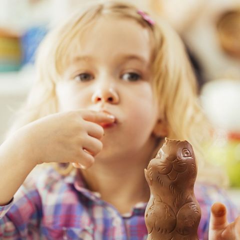little girl eating chocolate easter bunny