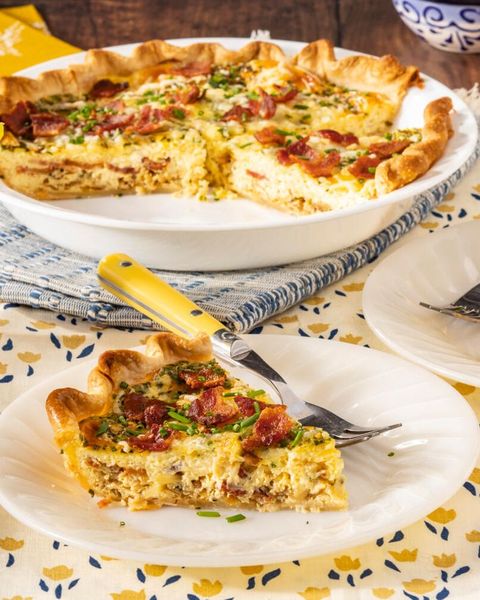 quiche lorraine on white plate with pie in back