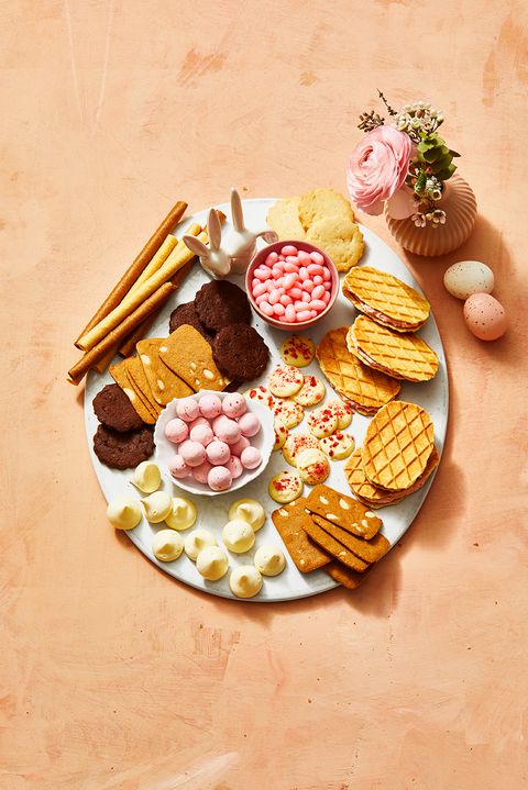 snack board with cookies, chocolates and spring candies