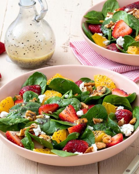 strawberry spinach salad in bowl with oranges