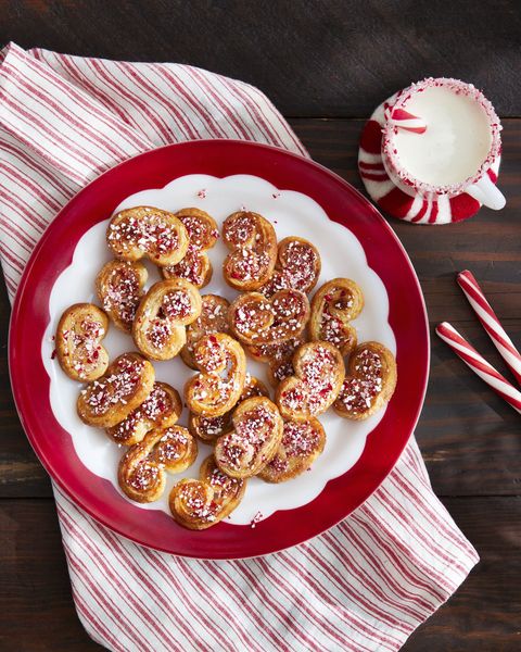 peppermint palmiers topped with crushed peppermints and arranged on a white plate with red trim