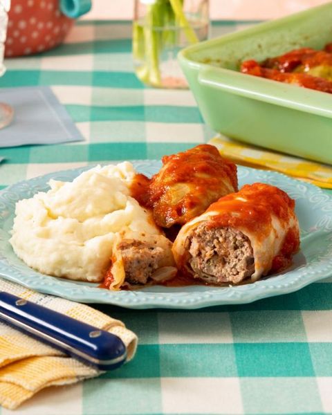 stuffed cabbage with mashed potatoes on light blue plate