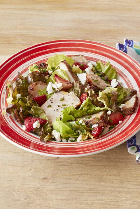 grilled pork salad with strawberries wood surface