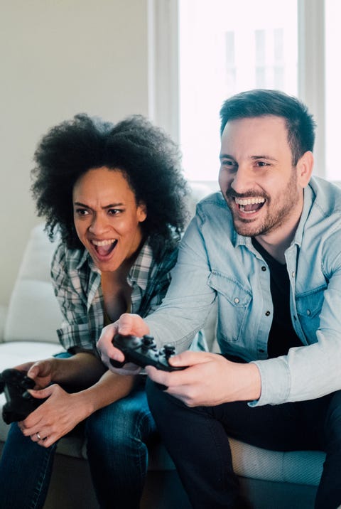 ecstatic young couple playing video games
