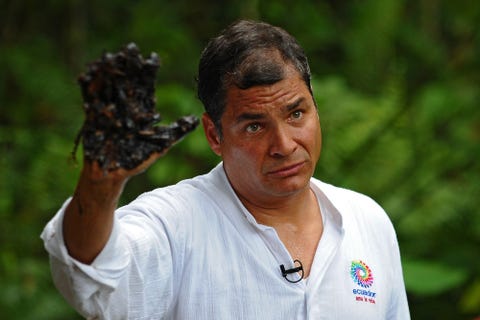ECUADOR-US-OIL-CORREA ecuadorean president rafael correa shows his oil covered hand at aguarico 4 oil well in aguarico, ecuador on september 17, 2013 aguarico 4 was operated by us oil company texaco between 1962 and 1990 correa called tuesday for a global boycott of chevron, as part of a campaign to highlight amazon environmental damage ecuador attributed to the us oil giant chevron has never worked directly in ecuador but inherited a pollution lawsuit when it acquired texaco in 2001, and has yet to pay an associated fine afp photo rodrigo buendia photo credit should read rodrigo buendiaafp via getty images