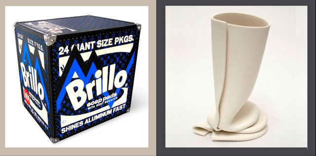 at left is a standalone piece of art in the shape of a blue black brillo box and at right is a fluid bone colored vase
