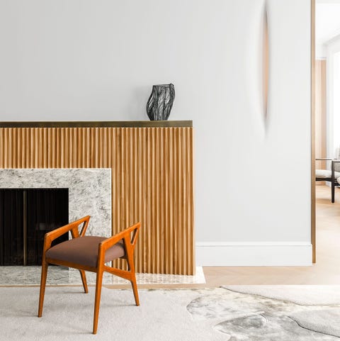 carpet that looks like marble in front of a wood fireplace that looks like corrugated cardboard