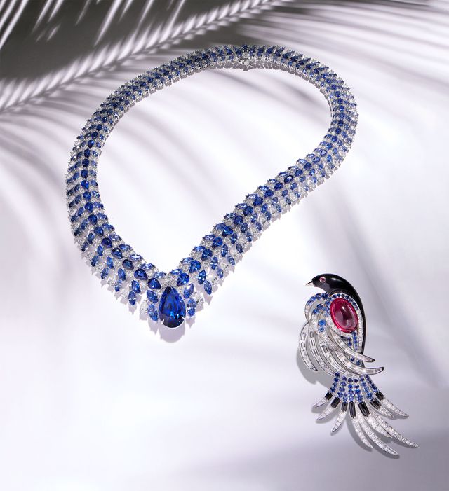 diamond and blue sapphire necklace with large teardrop sapphire at center and a bird brooch in diamonds and sapphires with a large red tourmaline on the wing and eye