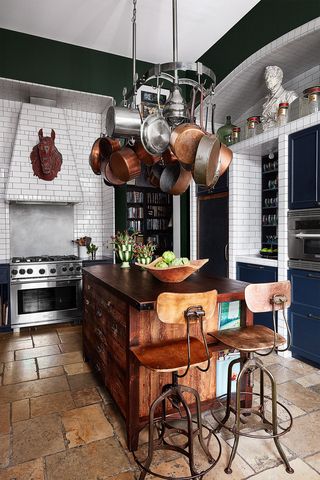 Kitchen with rustic wood table, wood body benches, metal legs and white brick walls