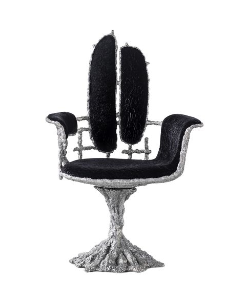 gothic looking black and metal swivel chair with partially open back and entwined pedestal base