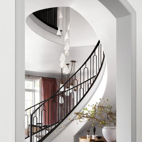sweeping staircase in white with black railings