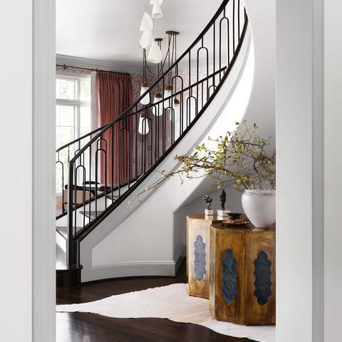 A List 2022 - ELLE DECOR sweeping staircase in white with black railings