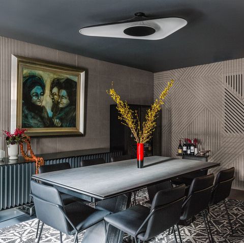 dining room with moody artwork on the wall
