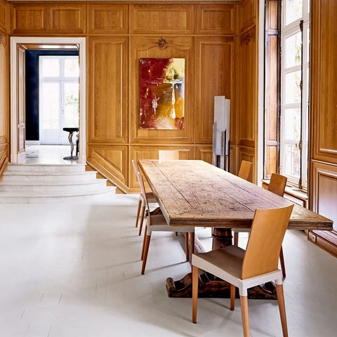 spacious long room with long wooden table and chairs