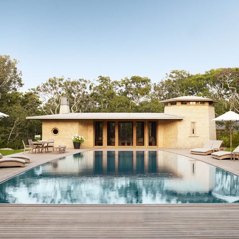 outdoor pool area with large cabana and umbrellas