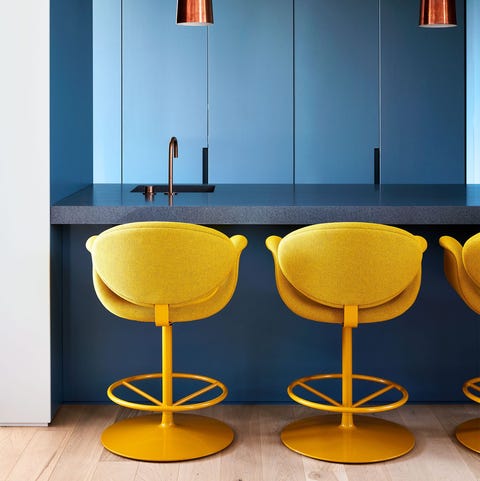 blue counter and walls with yellow stools