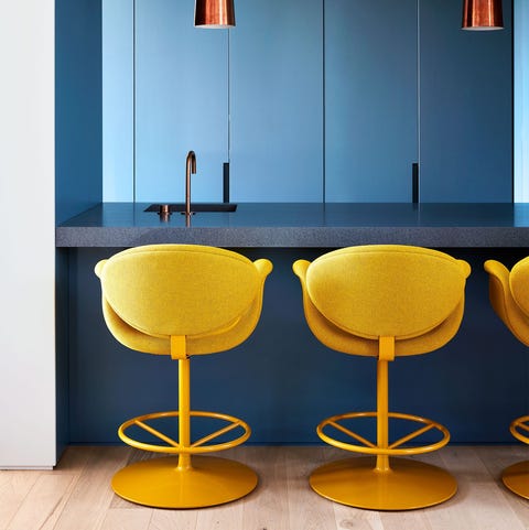A List 2022 - ELLE DECOR blue counter and walls with yellow stools