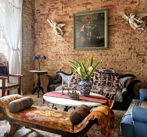 living area with brick wall and angel sconces