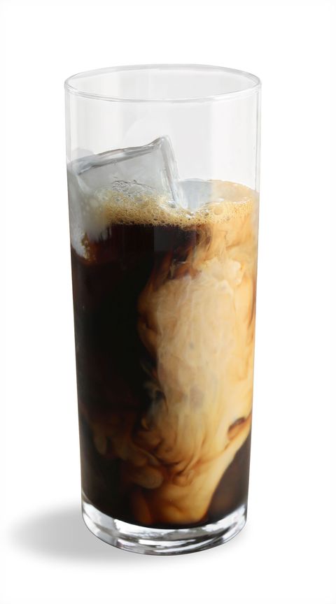 a tall refreshing glass of coffee with ice and a swirl of cream