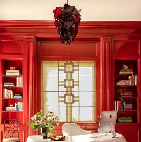 red asian inspired office with comma shaped white lacquer desk at center