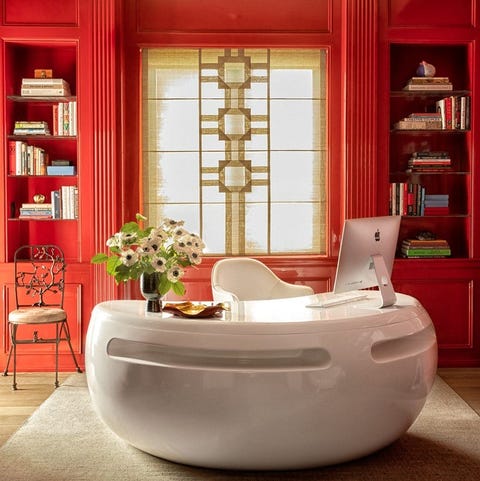 red asian inspired office with comma shaped white lacquer desk at center