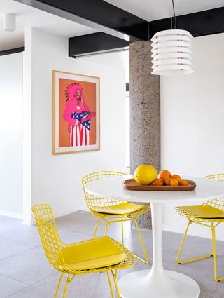 white breakfast table with  yellow chairs