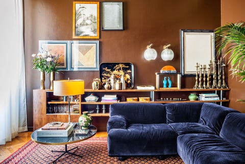 living room with blue sofa and antique candlesticks behind