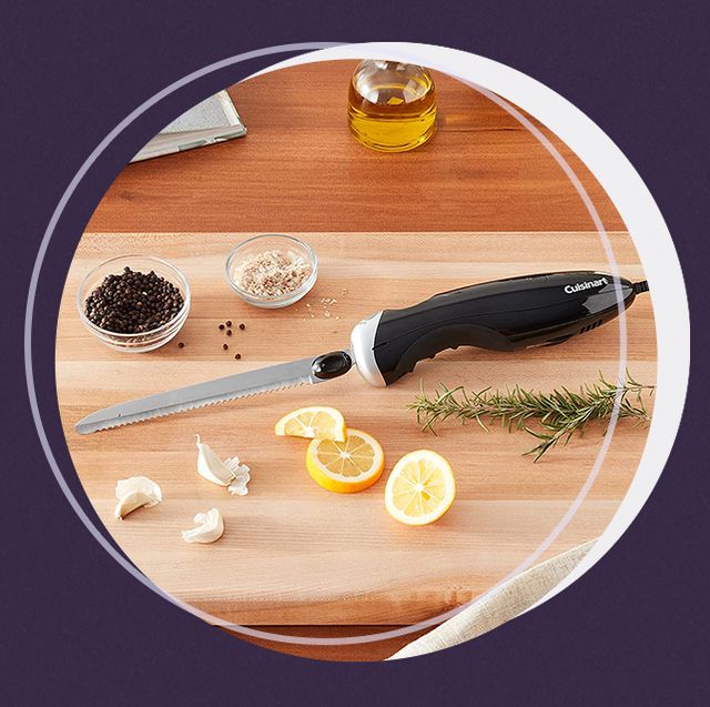 electric knife on cutting board with garlic lemon and rosemary