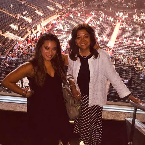 elizabeth in a black dress with vilma in a white cardigan standing in front of the stage at a concert