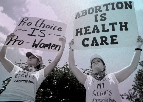 pro choice rally at the Georgia State Capitol building two women hold sings that read pro choice is pro women and abortion is health care