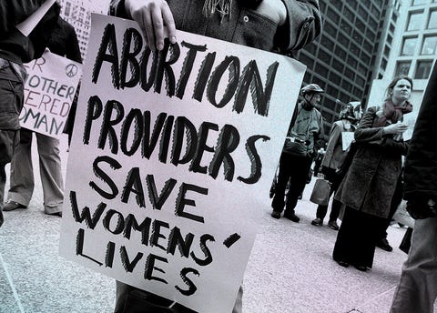 International Women's Day Rally Celebrates Women's Rights a rally participant holds a sign that reads "abortion providers save womens' lives" during an international women's day march in chicago