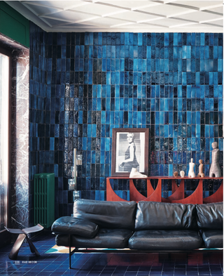 Living Room with glazed blue tiles and black leather sofa