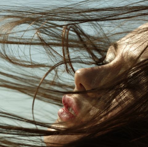 Caucasian woman with hair blowing in wind